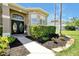 Inviting front entrance with stone accents, manicured shrubs, and decorative double doors at 5808 Oak Lake Trl, Oviedo, FL 32765
