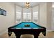 Billiards table surrounded by bright windows and recessed lights at 5808 Oak Lake Trl, Oviedo, FL 32765
