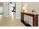 Hallway featuring tile floors, a decorative console table, and a glimpse into the bedroom at 5808 Oak Lake Trl, Oviedo, FL 32765