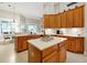 Bright kitchen featuring wood cabinets, stainless appliances, an island, and a breakfast table at 5808 Oak Lake Trl, Oviedo, FL 32765