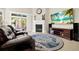 Comfortable living room with a fireplace, leather seating, and a sliding glass door at 5808 Oak Lake Trl, Oviedo, FL 32765