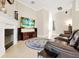 Cozy living area with a fireplace, leather seating, and an entertainment center at 5808 Oak Lake Trl, Oviedo, FL 32765