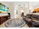Spacious living room with tile floors, a fireplace, and a view into the kitchen at 5808 Oak Lake Trl, Oviedo, FL 32765