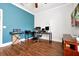 This well-lit home office offers hardwood floors, and a television at 5808 Oak Lake Trl, Oviedo, FL 32765