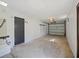 Clean garage with ample space for parking and storage featuring a roll up garage door at 614 Johnson Dr, Ormond Beach, FL 32174