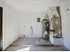 Utility room with a water heater, air conditioning unit, and laminate flooring at 614 Johnson Dr, Ormond Beach, FL 32174