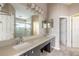 Bathroom with double vanity, neutral walls, large mirror and lots of natural light at 6794 Calistoga Cir, Port Orange, FL 32128