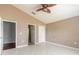 Bedroom featuring tile floors, ceiling fan, closet and natural light from doorway at 6794 Calistoga Cir, Port Orange, FL 32128