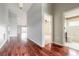 Spacious hallway with gleaming wood floors leading to various rooms in the home at 6794 Calistoga Cir, Port Orange, FL 32128