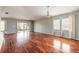 Bright living room featuring wood floors, a sliding glass door, and large windows at 6794 Calistoga Cir, Port Orange, FL 32128