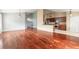 Open floor plan with wood floors connecting the living area and kitchen at 6794 Calistoga Cir, Port Orange, FL 32128