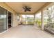 Screened in patio with ceiling fan, with a view of backyard landscaping and the home's exterior at 6794 Calistoga Cir, Port Orange, FL 32128