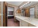 Bathroom showcasing floral wallpaper, vanity, and adjoining bedroom and closet at 7 Appaloosa Trl, Ormond Beach, FL 32174