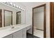 Bathroom with white vanity, a large mirror, and white tile floors at 7 Appaloosa Trl, Ormond Beach, FL 32174