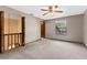 Bedroom with a ceiling fan, window, and doorway to an attached room at 7 Appaloosa Trl, Ormond Beach, FL 32174