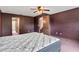 Bedroom featuring dark accent wall, ceiling fan, and adjacent room access at 7 Appaloosa Trl, Ormond Beach, FL 32174