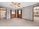 Large bedroom featuring a ceiling fan and views of an attached bathroom and hallway at 7 Appaloosa Trl, Ormond Beach, FL 32174