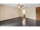 Empty bedroom featuring dark tile floors, ceiling fan, and ensuite bathroom at 7 Appaloosa Trl, Ormond Beach, FL 32174