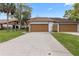 Attractive home featuring a large driveway and attached two-car garage at 7 Appaloosa Trl, Ormond Beach, FL 32174