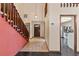 Inviting foyer features tile flooring, staircase, and views of the kitchen at 7 Appaloosa Trl, Ormond Beach, FL 32174