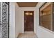 Inviting front entry with decorative security door and sidelight window at 7 Appaloosa Trl, Ormond Beach, FL 32174