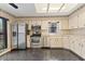 Bright kitchen featuring stainless steel appliances and black tile floors at 7 Appaloosa Trl, Ormond Beach, FL 32174