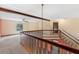Open loft area featuring wood beams and railings, offering a unique living space at 7 Appaloosa Trl, Ormond Beach, FL 32174
