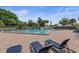 A large community pool featuring lounge chairs and tables with umbrellas for residents to enjoy at 7 Appaloosa Trl, Ormond Beach, FL 32174