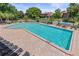 A large community pool featuring lounge chairs and tables with umbrellas for residents to enjoy at 7 Appaloosa Trl, Ormond Beach, FL 32174