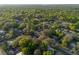 Wide aerial view of the residential community amidst lush greenery and mature trees at 782 Valencia Ave, Orange City, FL 32763