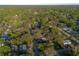 Wide aerial view of the residential community amidst lush greenery and mature trees at 782 Valencia Ave, Orange City, FL 32763