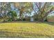 A large, grassy backyard with a storage shed and mature trees offers ample space at 782 Valencia Ave, Orange City, FL 32763