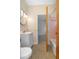 A clean bathroom features a white vanity, pink-tiled shower, and unique speckled flooring at 782 Valencia Ave, Orange City, FL 32763