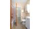 A well-maintained bathroom showcasing a white vanity, pink-tiled shower, and speckled flooring at 782 Valencia Ave, Orange City, FL 32763