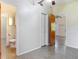 A bedroom reveals speckled floors and doorways to the bathroom and other living areas at 782 Valencia Ave, Orange City, FL 32763
