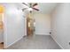 The neutral bedroom offers speckled flooring, a ceiling fan, and a doorway leading to another room at 782 Valencia Ave, Orange City, FL 32763
