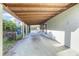 A spacious carport with a concrete floor and exposed wooden beams provides covered parking at 782 Valencia Ave, Orange City, FL 32763