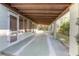 Covered carport with a concrete floor and wood beams provides ample parking and storage at 782 Valencia Ave, Orange City, FL 32763