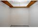 Inside the closet is wood shelving and a rod providing storage options in a small space at 782 Valencia Ave, Orange City, FL 32763