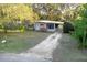 The home boasts a charming facade, a long carport, and a well-maintained front yard at 782 Valencia Ave, Orange City, FL 32763