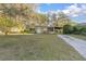 Charming single-story home with a well-maintained lawn and mature trees offering shade at 782 Valencia Ave, Orange City, FL 32763