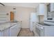 Bright kitchen with white cabinets, stainless steel appliances, and neutral countertops at 782 Valencia Ave, Orange City, FL 32763