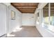 Enclosed patio featuring a concrete block wall, multiple windows, and a wood slat ceiling at 782 Valencia Ave, Orange City, FL 32763