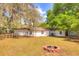 Large backyard with a fire pit, offering space for outdoor gatherings and enjoying the surrounding nature at 816 Overhill Rd, Deland, FL 32720