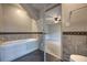 Bathroom featuring a soaking tub, tile work, and doorway leading to the bedroom at 816 Overhill Rd, Deland, FL 32720