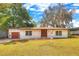 Charming single-story home featuring a well-manicured lawn, double front doors, and an attached one-car garage at 816 Overhill Rd, Deland, FL 32720