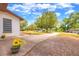 Inviting home exterior with a sunny lawn, flowering plants, and a long driveway leading to the residence at 816 Overhill Rd, Deland, FL 32720