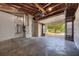 Spacious garage with exposed wooden rafters and an automatic door, providing ample space for vehicles at 816 Overhill Rd, Deland, FL 32720