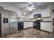 Well-appointed kitchen with stainless steel refrigerator, black appliances, and white cabinetry at 816 Overhill Rd, Deland, FL 32720