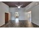 A spacious living room with dark plank ceiling and an arched doorway at 816 Overhill Rd, Deland, FL 32720